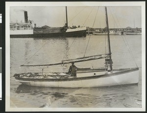 Fisherman posing with his boat full of catch, ca.1900