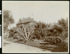 View of the south end of the grounds of the Hotel Redondo, showing a building in the background, ca.1905