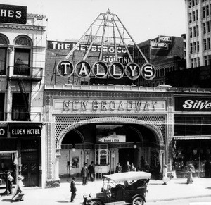 Exterior view of Tallys Theater, at the corner of Sixth Street and Brodway, showing a parked automobile, ca.1905-1910