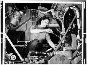 Woman working inside a tunnel of machinery