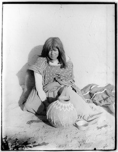 Mojave Indian woman bead worker with decorated pottery olla, or water jug, ca.1900