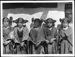 Five young Hopi Indian girls standing in a row in the village of Shonguapavi, ca.1901