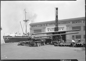 Steel pipes being loaded on a truck at Los Angeles Harbor, September 17, 1930