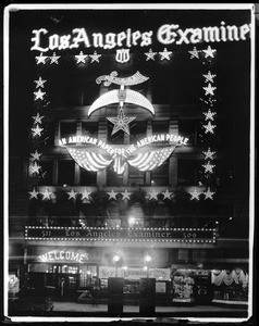 Exterior view of the Los Angeles Examiner building at night, showing special aluminous decorations for the Shriners convention, South Broadway