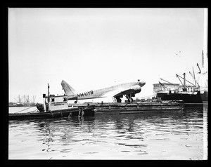 Douglas DC-2 plane at Los Angeles Harbor ready for shipment to Australia, 1937