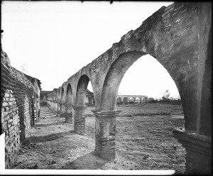 View of the outer perimeters (or the large courtyard?) of Mission San Juan Capistrano as seen from the arcade, Orange County, ca.1885