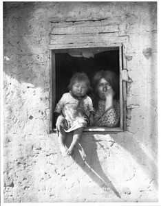 Yuma Indian mother and baby at the window of their dwelling, ca.1900