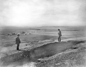 Two men on Olive Hill overlooking the Prospect Park Store and Post Office in Hollywood, California, ca.1905