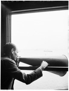 Man talking through a bull horn inside the Marine Exchange building in Los Angeles