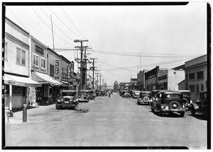 San Pedro street, showing automobiles and shops, ca.1920-1929