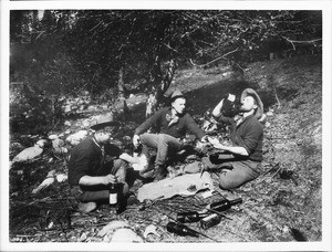 Men playing cards and drinking in the forest, ca.1930