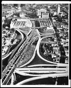 Low-altitude aerial view of Los Angeles, looking southwest toward City Hall, showing the U.S. Route 101 freeway, ca.1950-1959