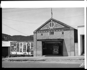 Exterior view of the Tujunga Valley Theater, showing hills in the background