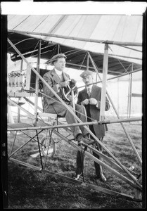 Aviators Clifford B. Harmon and Glenn Curtiss posing with a Curtiss biplane at the Dominguez Hills Air Meet, 1910