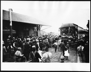 Veterans "Teddy's Terrors" waving goodbye from the back of a train at Colton Station, San Bernardino, ca.1904