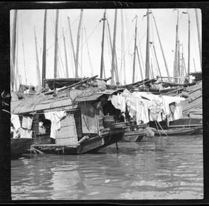 Laundry hanging from a river boat in China, ca.1900