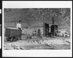 Men working on the aqueducts, showing three men manipulating a mechanism