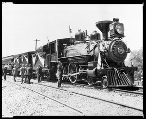 Men examining Engine 38 during the recreation of the Southern Pacific Line's completion, Soledad Canyon, September 5, 1926