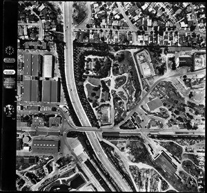 Aerial view of a freeway passing through Century City, May 6, 1959