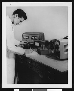 Man performing a lab test at the International Electronic Research Corp, ca.1940