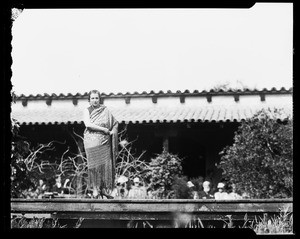 Woman standing on a platform, perhaps in the middle of a dance routine