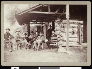 A group of fishing club members outside a mountain residence, ca.1910-1920