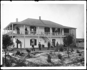 Ten members of the Vincente Lugo family pose at the ranch house, ca.1892