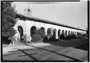 Exterior view of the San Fernando Mission, showing a cross on the roof