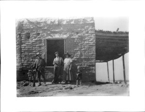 Family standing beside the stagecoach station on the Butterfield line, ca.1916