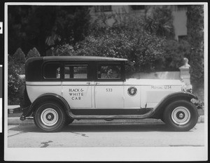 View of a 1930 or 1931 General Motors taxi operated by Black and White Cab Company, ca.1931