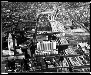 Aerial view of the Los Angeles Civic Center, looking west and showing a freeway under construction, ca.1953