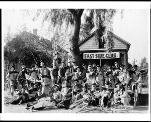 Group portrait of the members of the East Side Bicycling Club in Los Angeles, showing a banner for the club, ca.1896