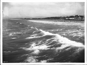 Long Beach from across the surf, showing the Hotel Bixby under construction in the distance at right, ca.1906