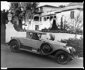Portrait of A.E. Bell in his Rolls Royce automobile in front of his office