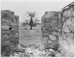 View looking through the doorway of an old adobe ruins in Ventura County, ca.1900