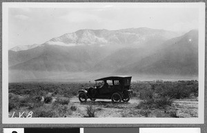 Automobile parked on a desert road, ca.1910