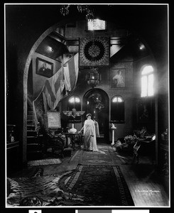 Portrait of Mrs. Vesey O'Doveren (Ivy DeVerley) in the gallery of her home in Hollywood, ca.1920-1929