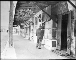 The sidewalk in Sonora Town on the east side of North Spring Street, Los Angeles, ca.1920-1929