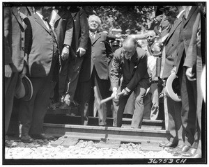 "Wedding of the rails", showing a man hammering in a railroad spike, 1926