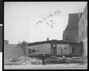 Man examining the ruins of the OA Hale & Co. building, caused by 1906 earthquake in San Jose, 1906