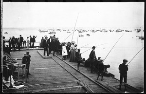 People fishing off of the side of the pier at Redondo Beach, 1905