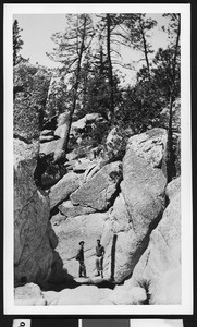 Hikers in Chilao Canyon gorge located one half-mile west of Chilao Ranger Station, ca.1940