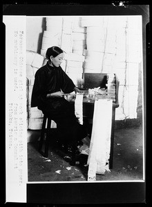 Formosan Chinese girl slicing pith into paper in Taihoku, Taiwan