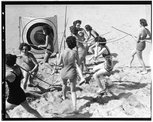 Women playing archery on the sand of a Los Angeles area beach, ca.1940