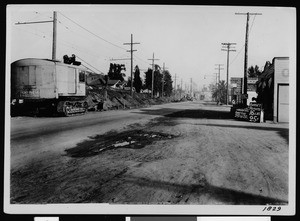 View of a pothole in an unidentified street before it was resurfaced