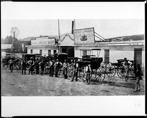 Portrait of men posed in front of carriages outside of Louis Roeder's Blacksmith Shop, Los Angeles, ca.1878