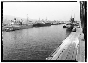 Ships docked along a wharf in San Pedro Harbor