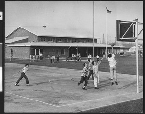 Boys playing basketball at a Los Angeles park, ca.1940