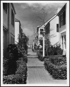 Brick walkway between duplex-style apartment buildings, 1935