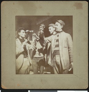 Men lifting their glasses of beer in a toast, ca.1920